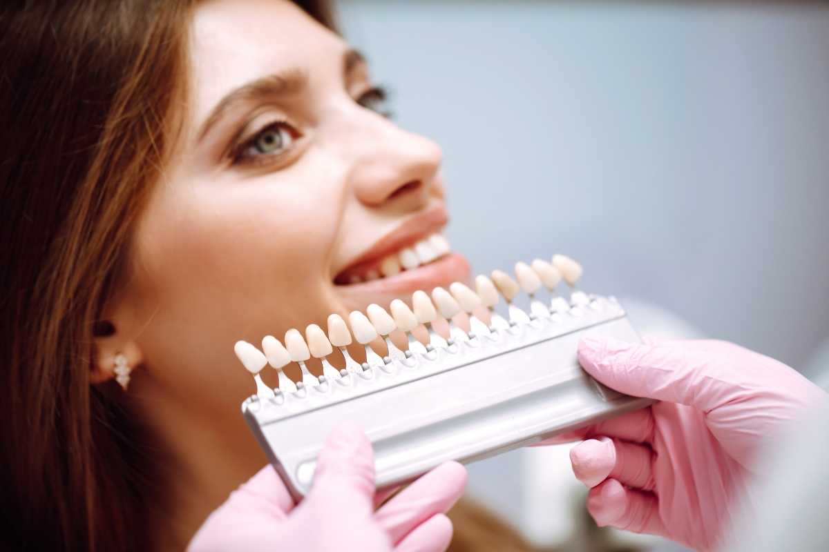 Patient comparing veneer shade options for a natural cosmetic smile makeover