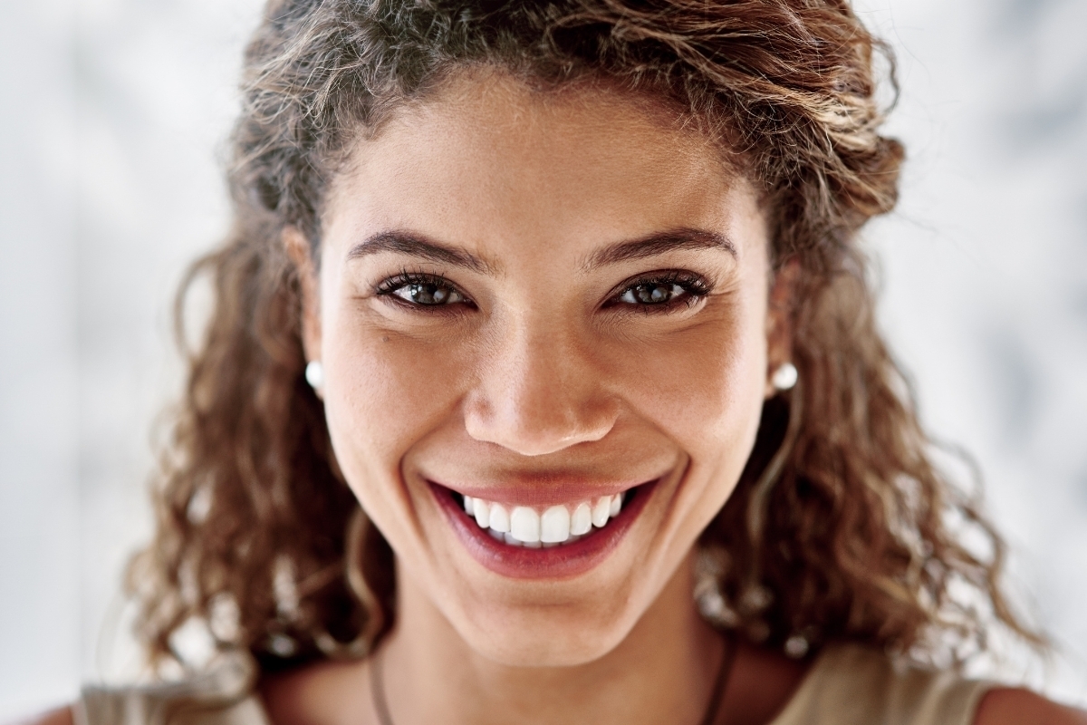 Woman smiling showing bright white teeth, representing successful cosmetic dental results in Scottsdale.